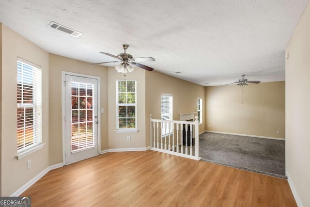 40 Wimberly Way, Covington, GA 30016 - unfurnished room with ceiling fan, light wood-style floors, baseboards, and a textured ceiling