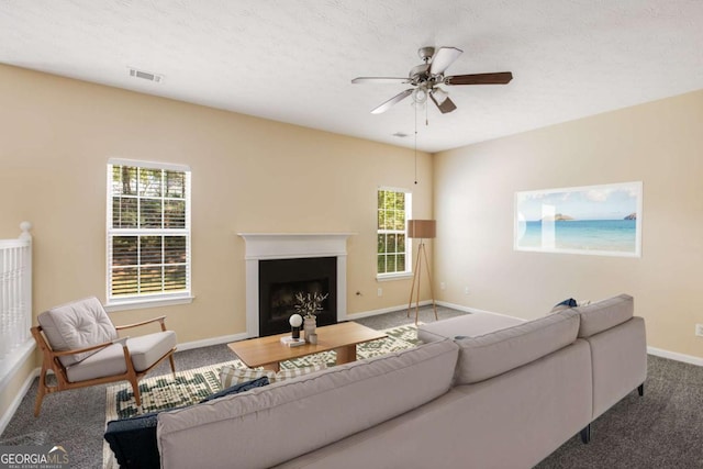 40 Wimberly Way, Covington, GA 30016 - living room with carpet floors, baseboards, a ceiling fan, and a fireplace