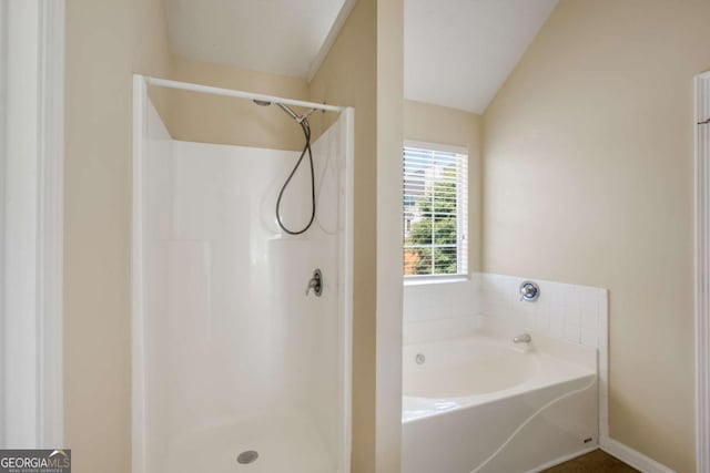 40 Wimberly Way, Covington, GA 30016 - bathroom with a garden tub, a shower, vaulted ceiling, and baseboards