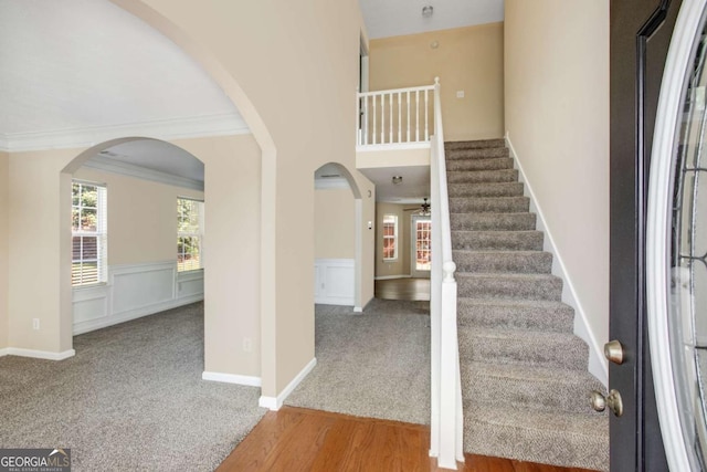 40 Wimberly Way, Covington, GA 30016 - entrance foyer with arched walkways, carpet floors, wainscoting, stairs, and ornamental molding