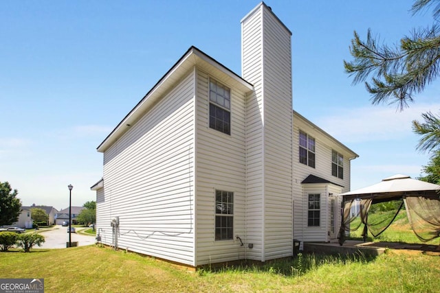 40 Wimberly Way, Covington, GA 30016 - view of side of property with a gazebo, a chimney, and a yard