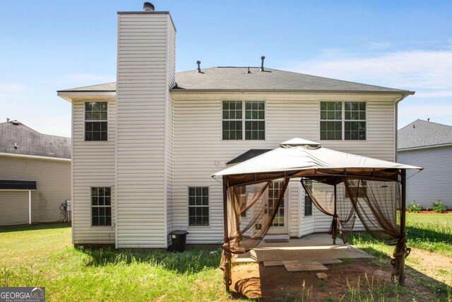 40 Wimberly Way, Covington, GA 30016 - back of house with a gazebo and a chimney
