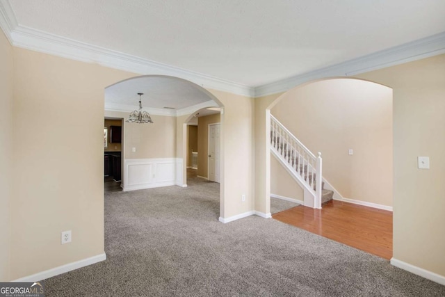 40 Wimberly Way, Covington, GA 30016 - unfurnished room featuring carpet floors, ornamental molding, arched walkways, stairway, and a wainscoted wall