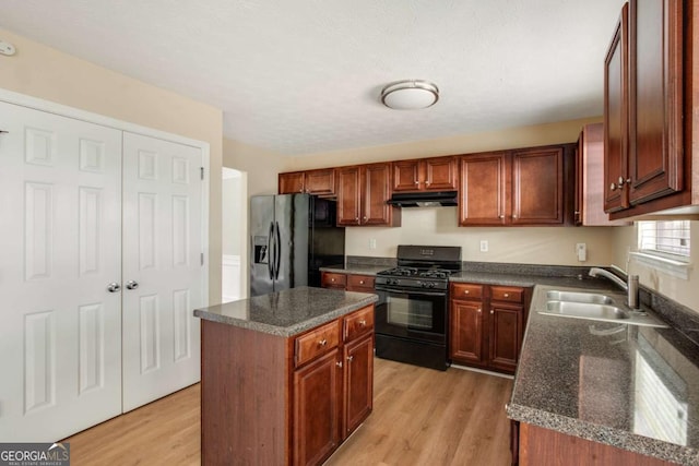 40 Wimberly Way, Covington, GA 30016 - kitchen with black appliances, a sink, light wood-style flooring, under cabinet range hood, and a center island