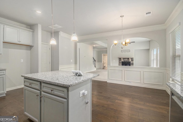 206 Brookview Dr, Newnan, GA 30265 - kitchen with crown molding, dark wood finished floors, gray cabinetry, arched walkways, and decorative light fixtures