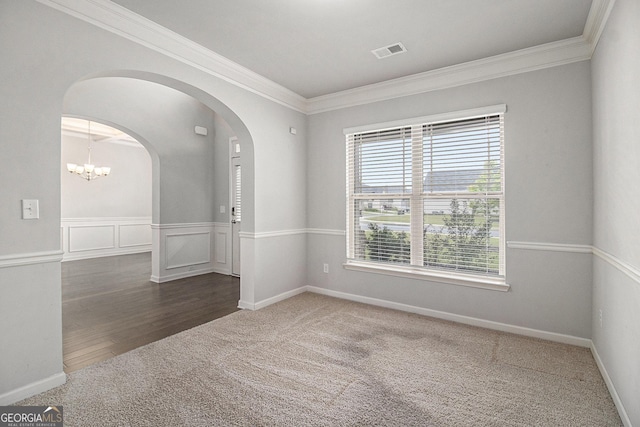 206 Brookview Dr, Newnan, GA 30265 - unfurnished room featuring arched walkways, ornamental molding, carpet flooring, a chandelier, and wood finished floors