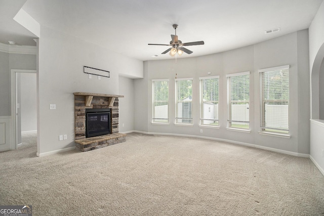 206 Brookview Dr, Newnan, GA 30265 - unfurnished living room with carpet floors, a ceiling fan, a stone fireplace, and baseboards