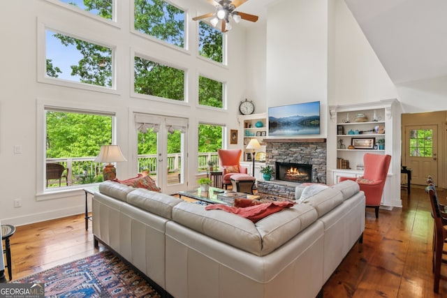 61 Deer Run Rdg, Big Canoe, GA 30143 - living room with a high ceiling, dark wood-style flooring, a ceiling fan, a fireplace, and baseboards