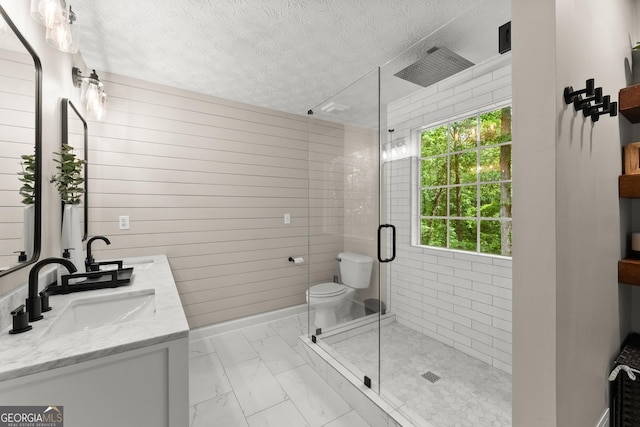 6520 Glen Pond Trce, Cumming, GA 30028 - bathroom with marble finish flooring, a textured ceiling, a shower stall, double vanity, and toilet