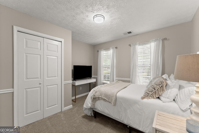 6520 Glen Pond Trce, Cumming, GA 30028 - carpeted bedroom featuring a closet, a textured ceiling, and baseboards