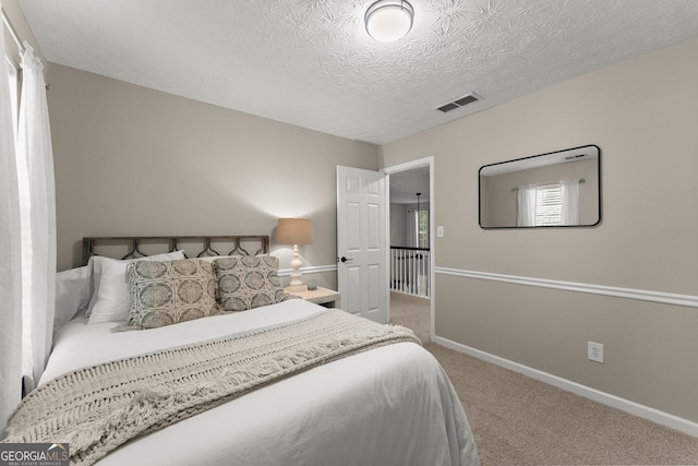 6520 Glen Pond Trce, Cumming, GA 30028 - carpeted bedroom with baseboards and a textured ceiling