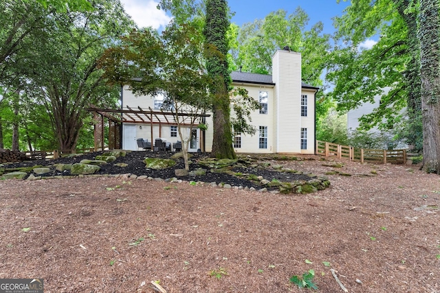 6520 Glen Pond Trce, Cumming, GA 30028 - rear view of house with a pergola, a chimney, and fence