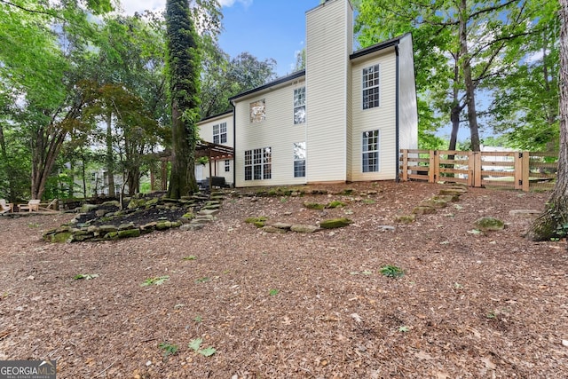 6520 Glen Pond Trce, Cumming, GA 30028 - view of home's exterior featuring a chimney and fence