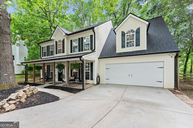 6520 Glen Pond Trce, Cumming, GA 30028 - view of front facade with a porch, concrete driveway, fence, a garage, and roof with shingles