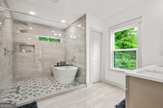 2318 Polar Rock Ter, Atlanta, GA 30315 - full bathroom featuring vanity, a shower stall, a soaking tub, baseboards, and recessed lighting