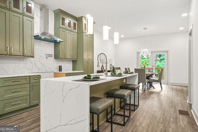 2318 Polar Rock Ter, Atlanta, GA 30315 - kitchen with green cabinetry, wall chimney exhaust hood, tasteful backsplash, dark wood-style floors, and recessed lighting