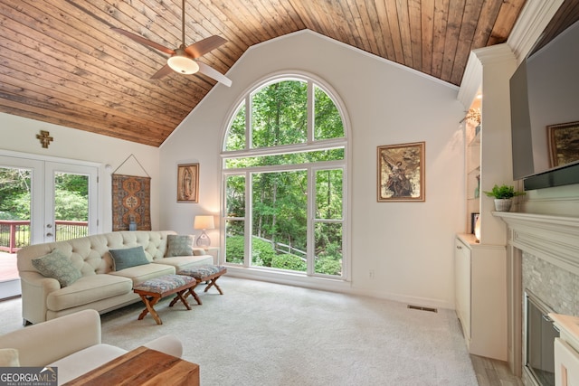 420 Windswept Ct, Roswell, GA 30075 - living area with french doors, a ceiling fan, baseboards, a fireplace, and light carpet