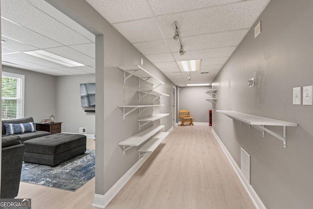 420 Windswept Ct, Roswell, GA 30075 - hallway featuring wood finished floors, a paneled ceiling, baseboards, and track lighting