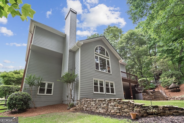 420 Windswept Ct, Roswell, GA 30075 - rear view of property with a chimney, stairs, a wooden deck, and a lawn