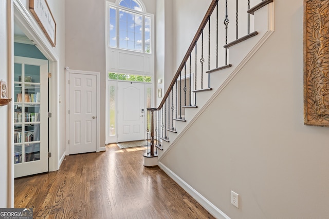 420 Windswept Ct, Roswell, GA 30075 - foyer entrance with a high ceiling, wood finished floors, stairs, and baseboards