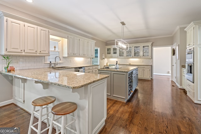 420 Windswept Ct, Roswell, GA 30075 - kitchen with a sink, a peninsula, decorative backsplash, a center island, and dark wood finished floors