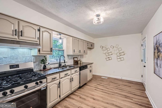 9 Windsor Way, Newnan, GA 30263 - kitchen featuring appliances with stainless steel finishes, under cabinet range hood, a sink, light wood finished floors, and a textured ceiling