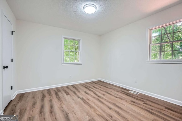 9 Windsor Way, Newnan, GA 30263 - unfurnished room with wood finished floors, a textured ceiling, and baseboards