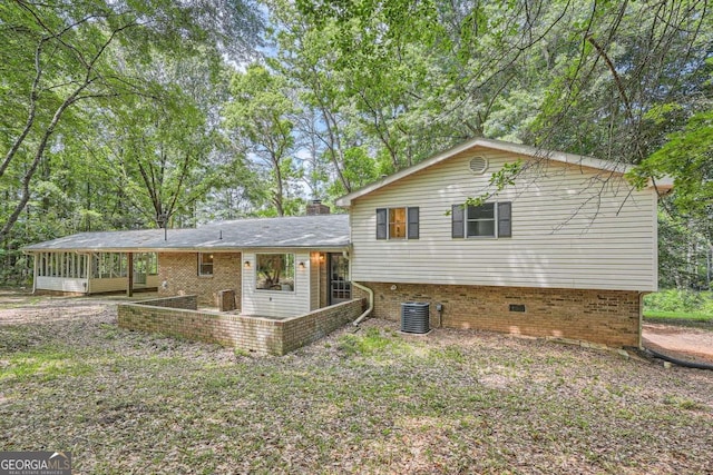 9 Windsor Way, Newnan, GA 30263 - view of front of property featuring a sunroom, brick siding, central AC unit, and a chimney