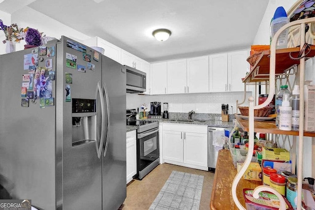 1150 Rankin St Unit 19O, Stone Mountain, GA 30083 - kitchen featuring stainless steel appliances, a sink, white cabinetry, and light stone countertops