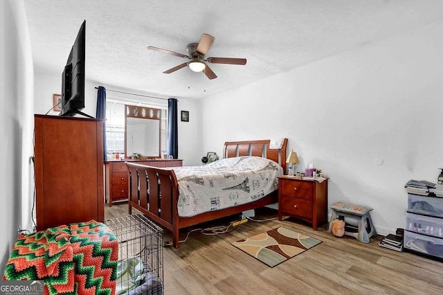 1150 Rankin St Unit 19O, Stone Mountain, GA 30083 - bedroom with light wood-style flooring, ceiling fan, and a textured ceiling