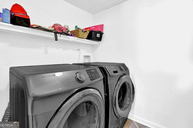 1150 Rankin St Unit 19O, Stone Mountain, GA 30083 - laundry room featuring washing machine and clothes dryer and baseboards