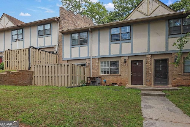 1150 Rankin St Unit 19O, Stone Mountain, GA 30083 - view of front of home featuring a front lawn, brick siding, and stucco siding