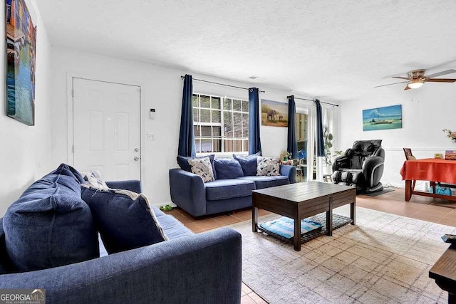 1150 Rankin St Unit 19O, Stone Mountain, GA 30083 - living area featuring light tile patterned floors, ceiling fan, and a textured ceiling
