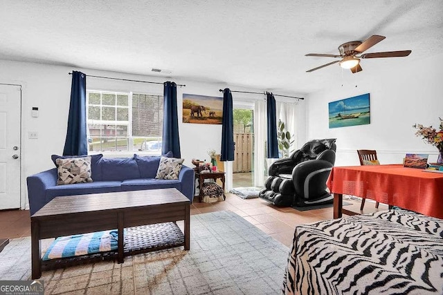1150 Rankin St Unit 19O, Stone Mountain, GA 30083 - tiled living area with healthy amount of natural light, a ceiling fan, and a textured ceiling