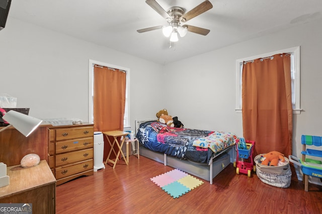 bedroom with wood finished floors and ceiling fan