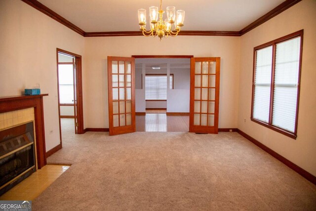 298 S Main St, Baxley, GA 31513 - unfurnished dining area featuring french doors, a tiled fireplace, ornamental molding, carpet floors, and a chandelier