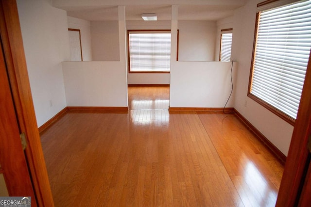 298 S Main St, Baxley, GA 31513 - empty room with light wood-style flooring and baseboards