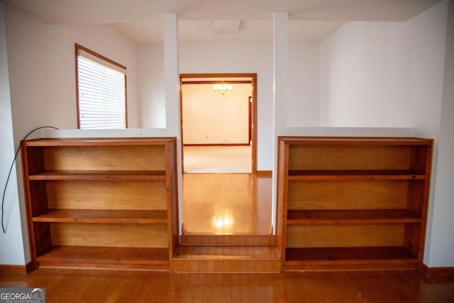 298 S Main St, Baxley, GA 31513 - stairs featuring wood finished floors, a chandelier, and baseboards