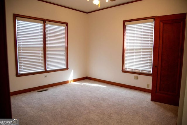 298 S Main St, Baxley, GA 31513 - empty room with carpet flooring, baseboards, crown molding, and ceiling fan