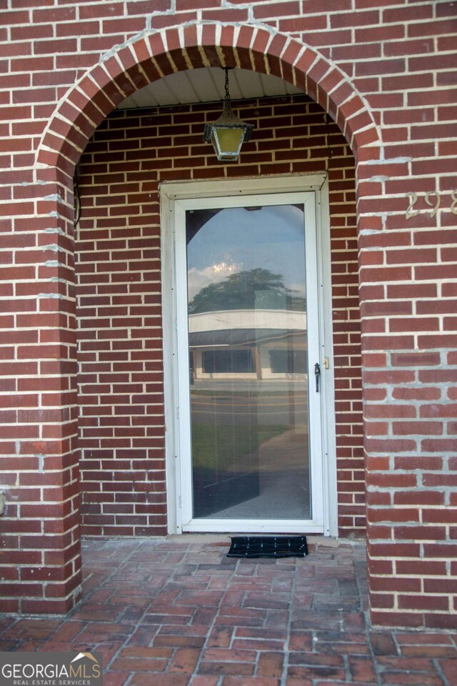 298 S Main St, Baxley, GA 31513 - doorway to property with brick siding