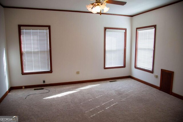 298 S Main St, Baxley, GA 31513 - spare room with carpet, ornamental molding, baseboards, and a ceiling fan