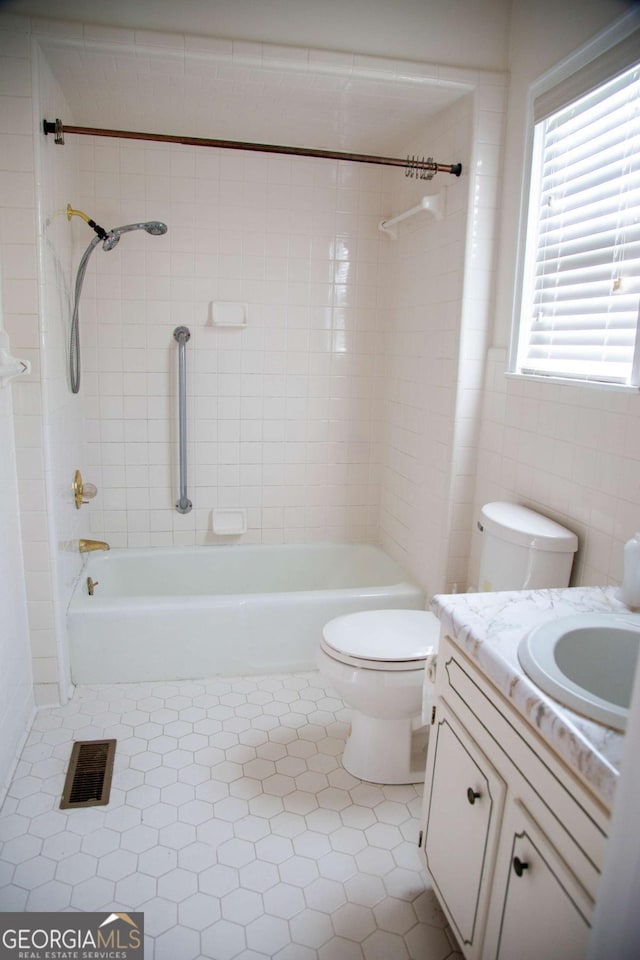 298 S Main St, Baxley, GA 31513 - bathroom featuring toilet, vanity, tile patterned flooring, and shower / tub combination