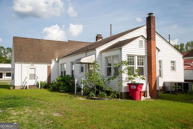 298 S Main St, Baxley, GA 31513 - back of property featuring entry steps, a chimney, and a yard