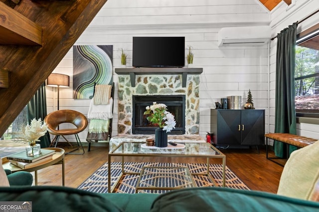 106 Taylor Ridge Rd, Blue Ridge, GA 30513 - living room featuring a wall mounted air conditioner, wood-type flooring, wooden walls, and a fireplace