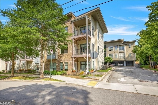 22 Moda Ln, Atlanta, GA 30316 - view of building exterior featuring driveway and a garage