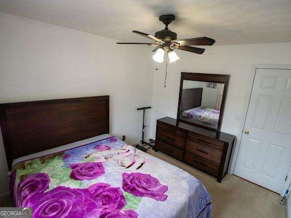 carpeted bedroom with a ceiling fan