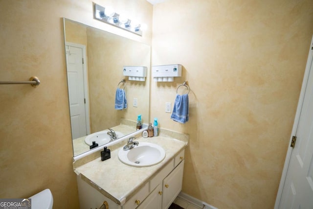 bathroom featuring vanity and toilet