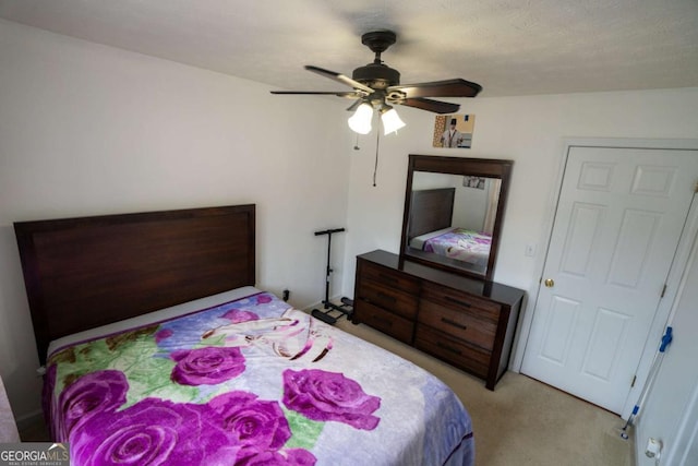 bedroom with light carpet and ceiling fan