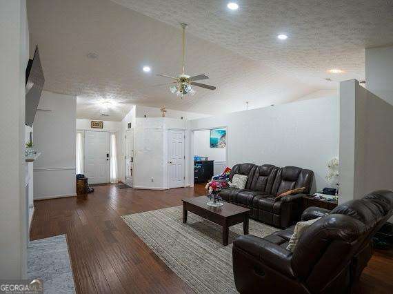 living room with ceiling fan, vaulted ceiling, wood finished floors, and recessed lighting