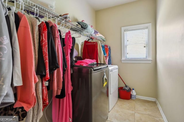 1520 Ethans Way, Mcdonough, GA 30252 - laundry room featuring washing machine and dryer, tile patterned floors, and baseboards